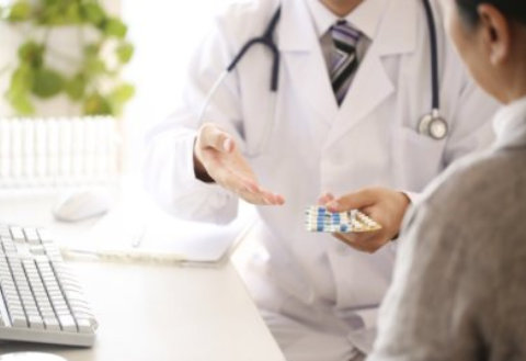 doctor prescribing medication to senior woman patient